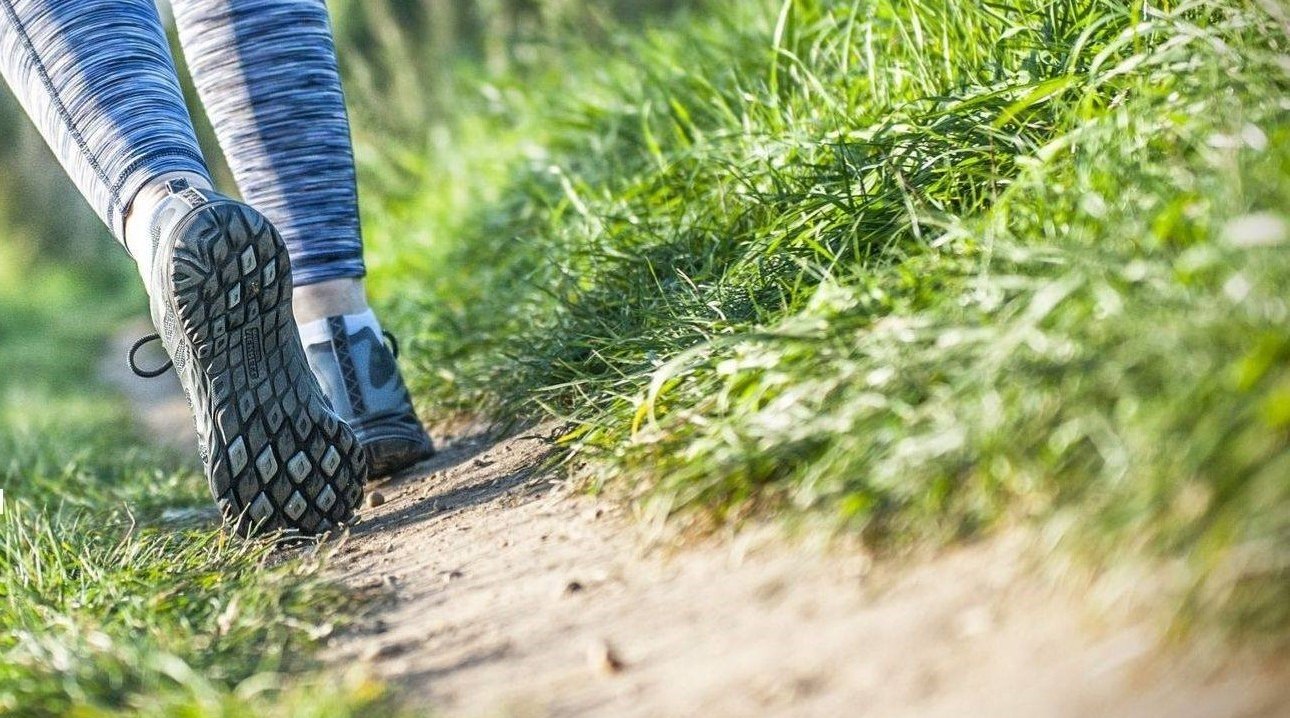 feet with walking shoes on a countryside path