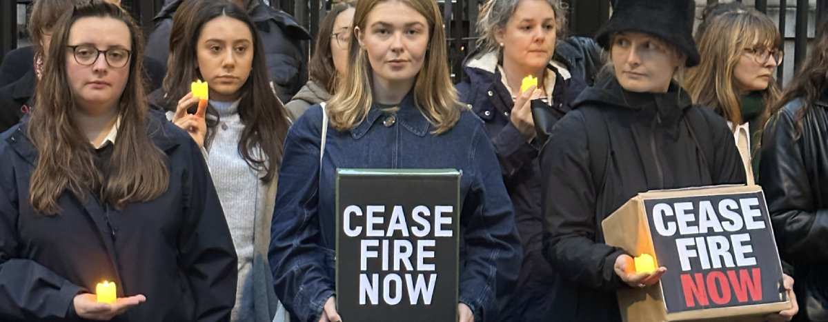 A group of people stand outside Downing Street looking downcase