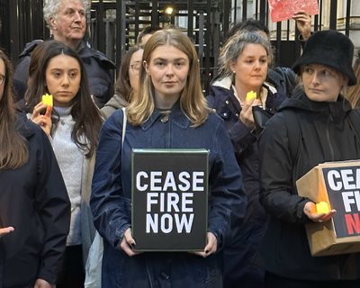 A group of people stand outside Downing Street looking downcase