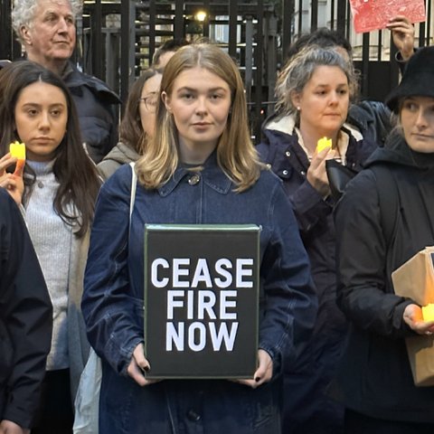 A group of people stand outside Downing Street looking downcase