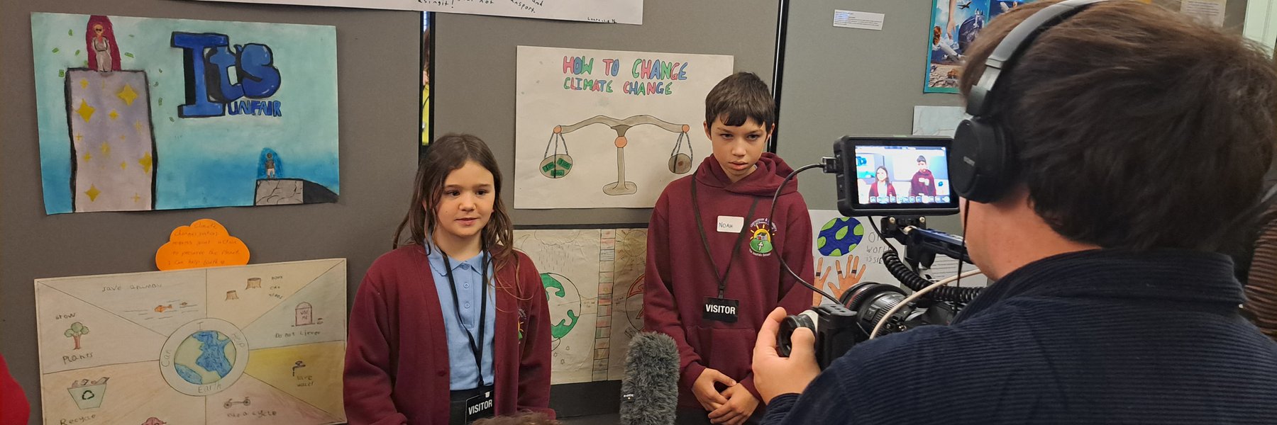 Young people are interviewed by the media at the Get Creative for Climate Justice exhibition