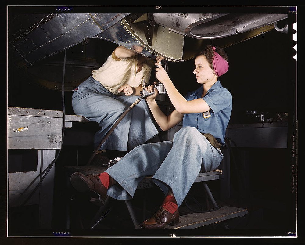 White 20 or 30-something women at work on bomber dressed in denim, Douglas Aircraft Company, Long Beach, Calif.