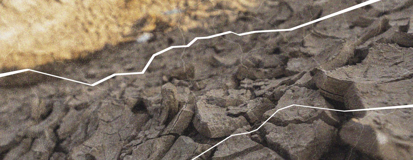 Close-up of dry, cracked earth with white contour lines overlaid, highlighting the uneven surface and texture of the ground.