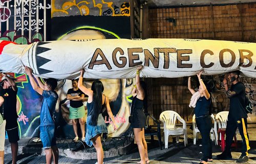 Activists holding a giant snake - Agente Cobra, The Cobra Agent that symbolises a demand for change.