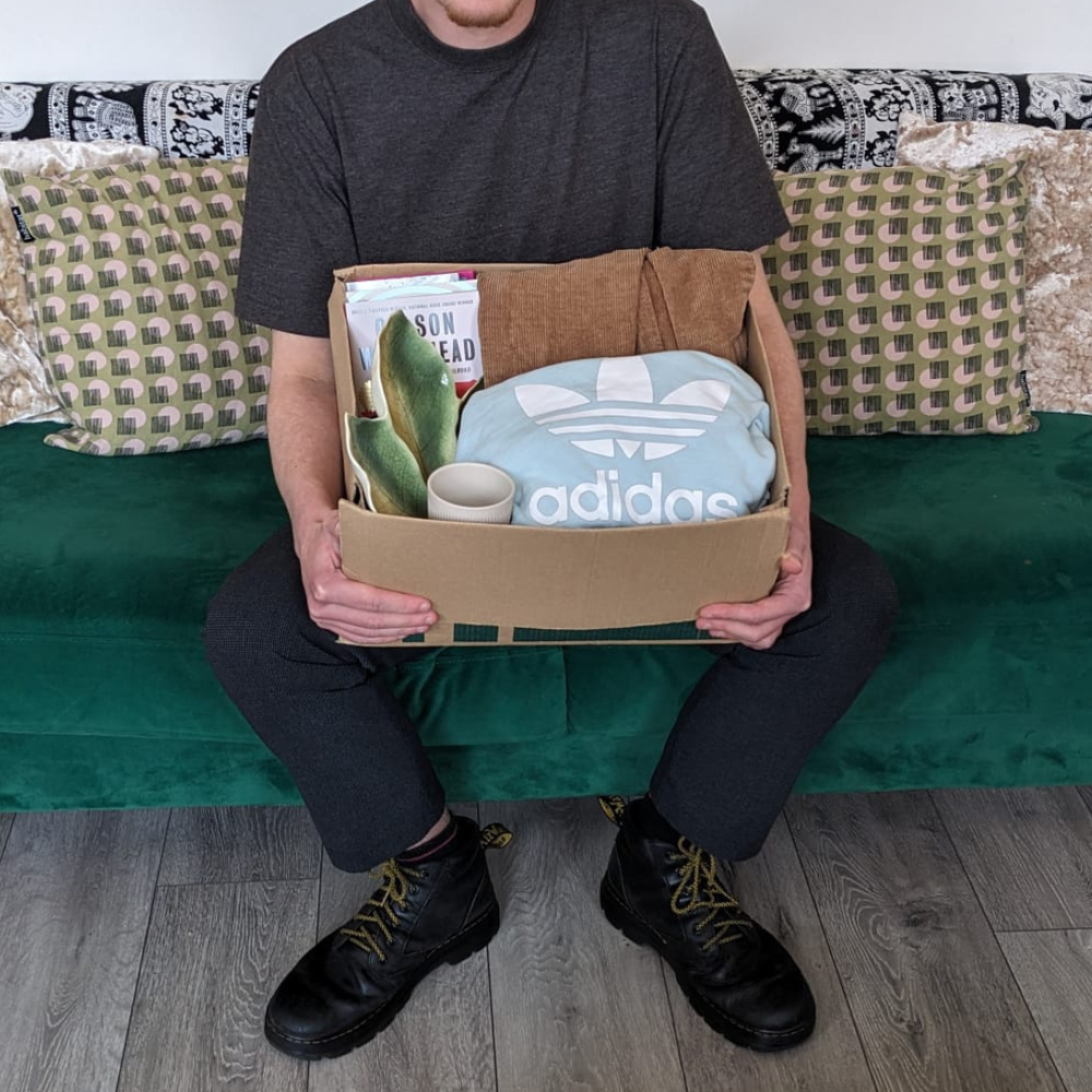 Image of a person holding a box of donations