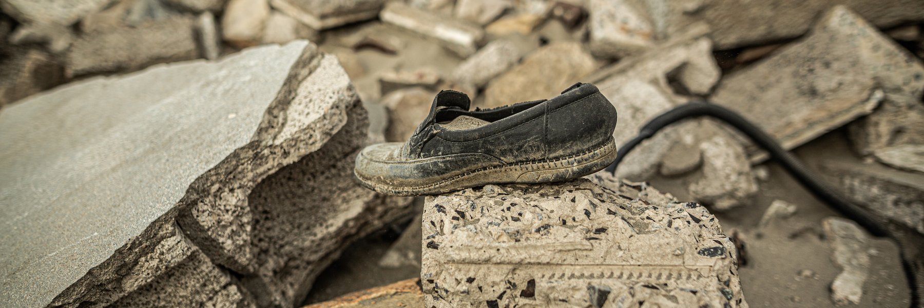A single shoe sits on top of a pile of rubble in Arish, Yemen