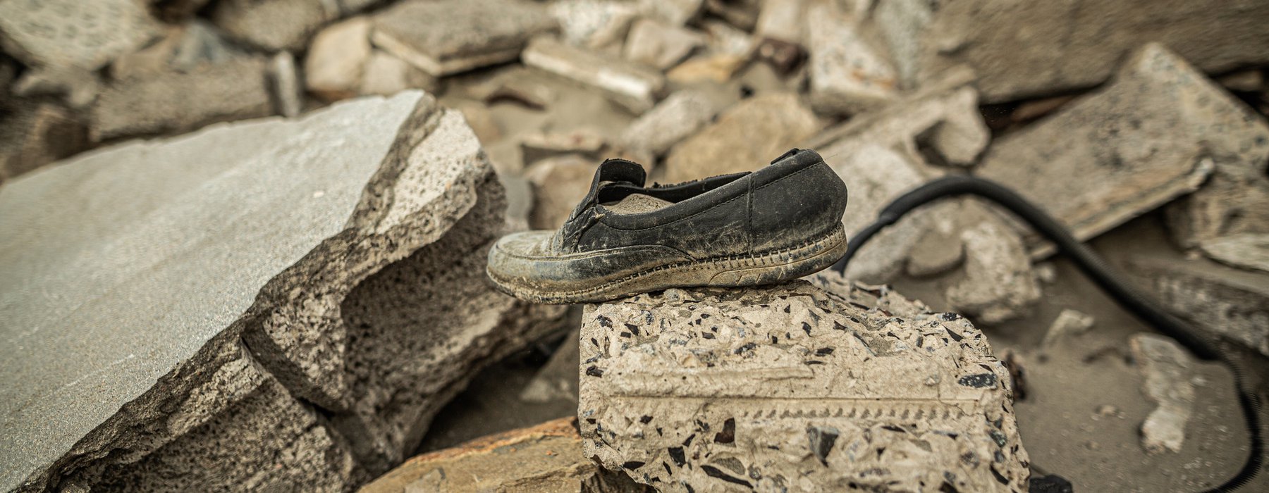 A single shoe sits on top of a pile of rubble in Arish Yemen