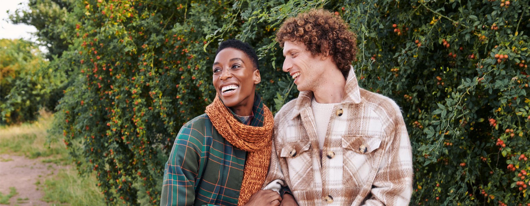 A women and a man dressed in clothes from the Oxfam Online Shop