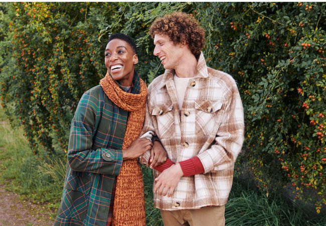 A women and a man dressed in clothes from the Oxfam Online Shop