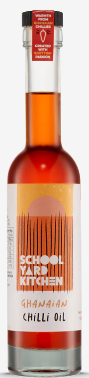 A bottle of red chilli oil, with a label that reads 'School Yard Kitchen: Ghanaian Chilli Oil.'