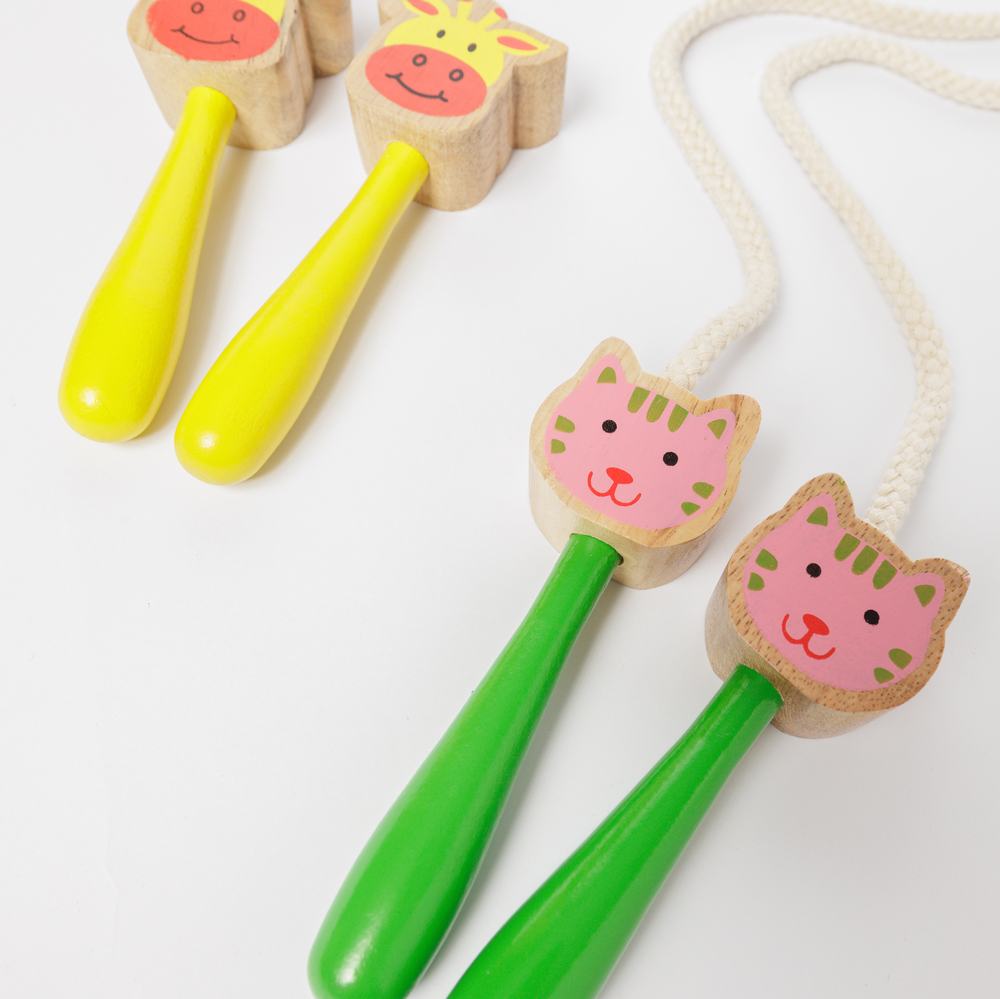Two colourful skipping ropes laid flat. One is a giraffe design, and one is a cat.