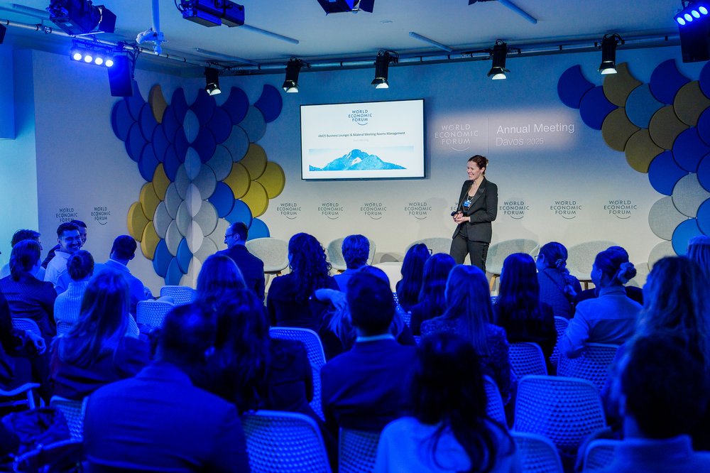 An audience seated in a conference hall watching a presentation at the World Economic Forum Annual Meeting in Davos, 2025.