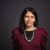 Woman with long hair wearing a bead necklace