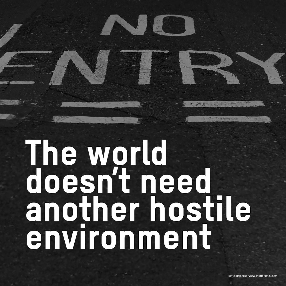 An image of a road that says no entry with test that says 'the world doesn't need another hostile environment'