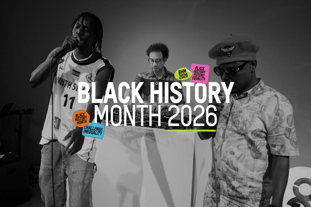 Black and white photograph three men performing a song. One is a DJ at his decks and two are stood in front holding microphones to their mouths. The text over the image reads Black History Month 2026