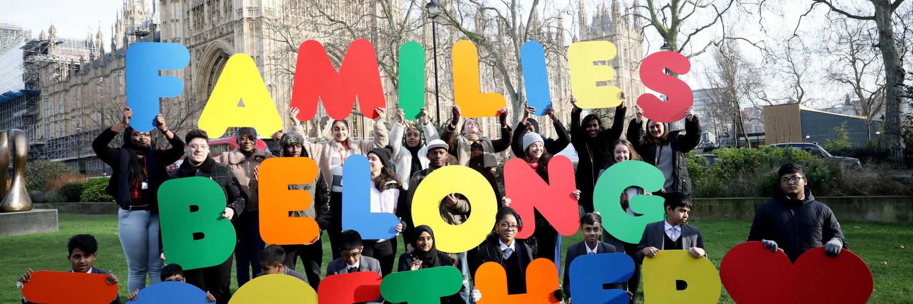 Campaigners hold large letters spelling 'Families Belong Together'