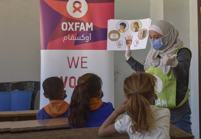 An Oxfam volunteer tells schoolchildren in Aleppo about the four key times for handwashing, based on the Mum's Magic Hands curriculum