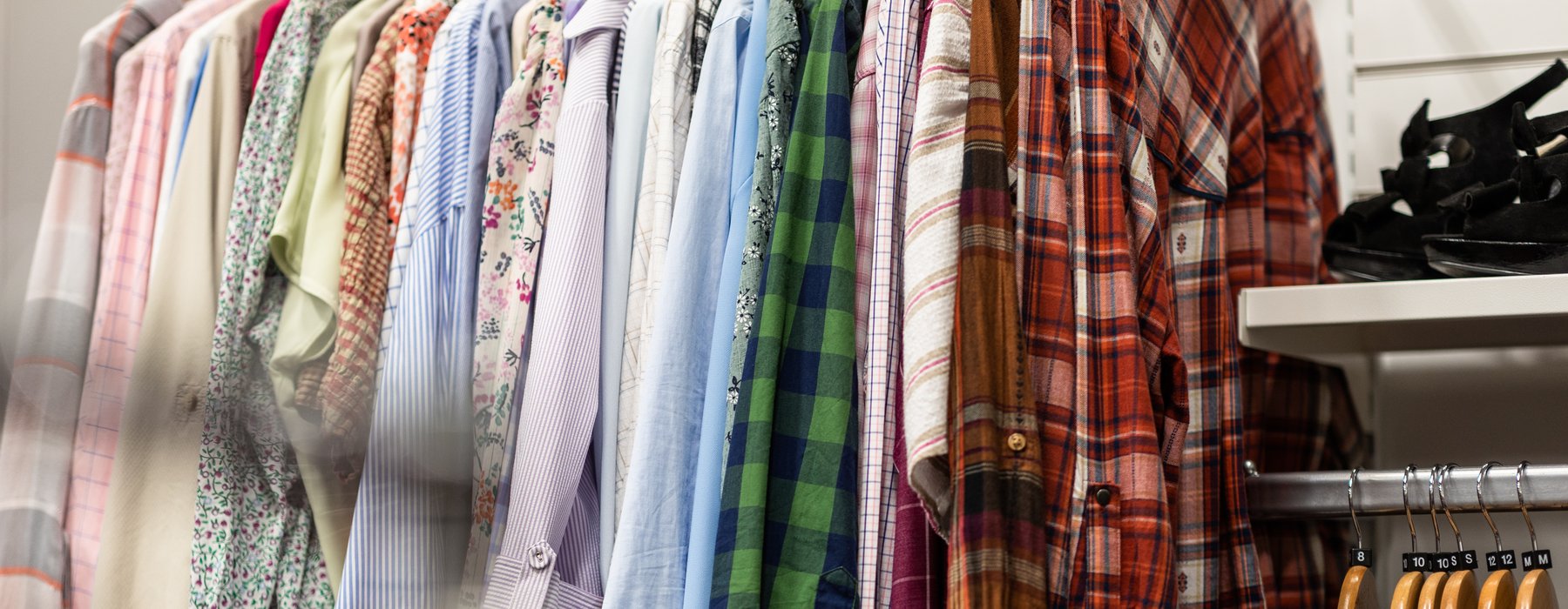 A rail of shirts in an Oxfam shop.