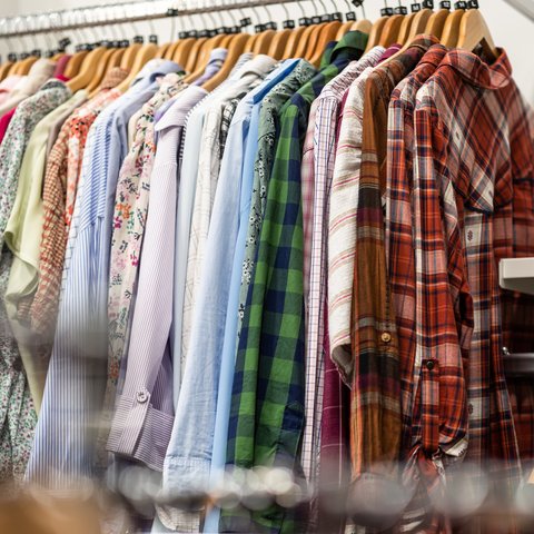 A rail of shirts in an Oxfam shop.