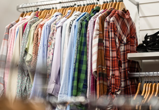 A rail of shirts in an Oxfam shop.