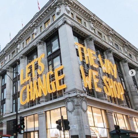 A building with the words 'let's change how we shop' on the sides