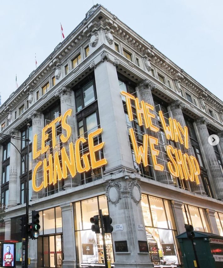 A building with the words 'let's change how we shop' on the sides