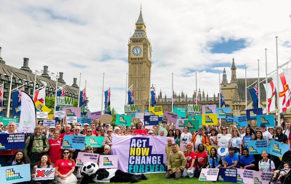The Climate Coalition outside of Westminster all holding banners
