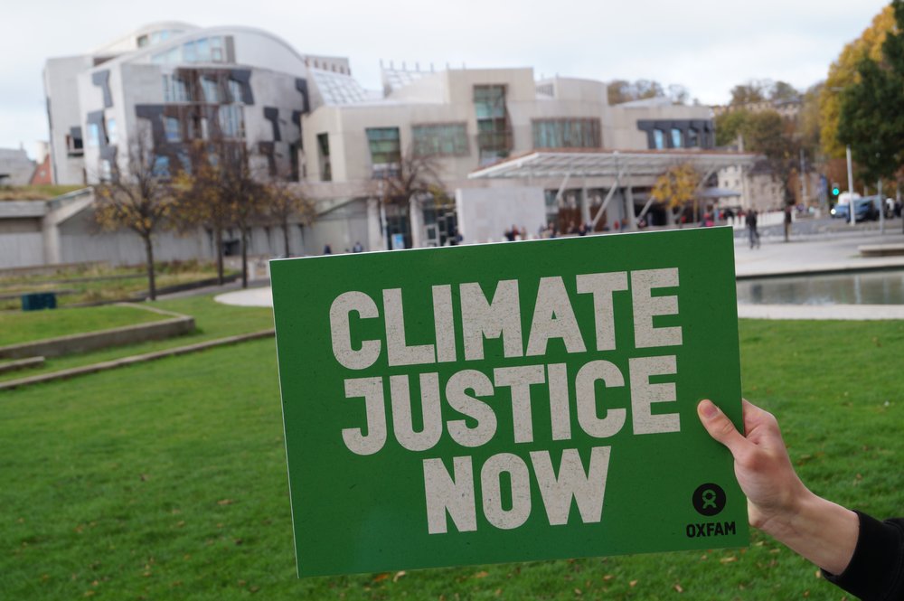 Board reading climate justice now held in front of Scottish Parliament