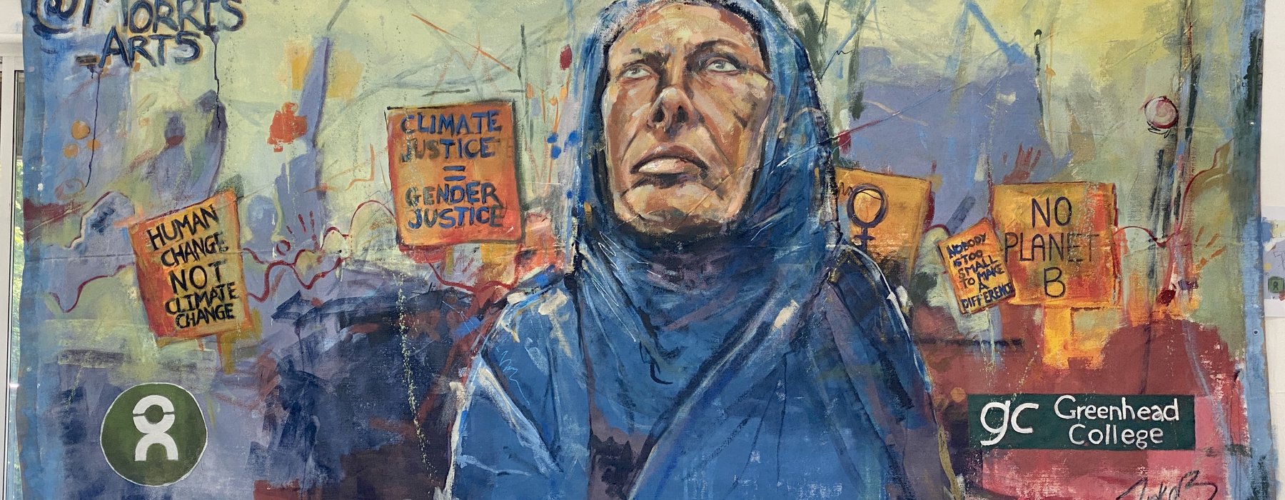 A painting of a woman in blue hijab looking to the sky with banners behind her saying 'human change not climate change' and 'climate justice = gender justice' and 'no planet B'