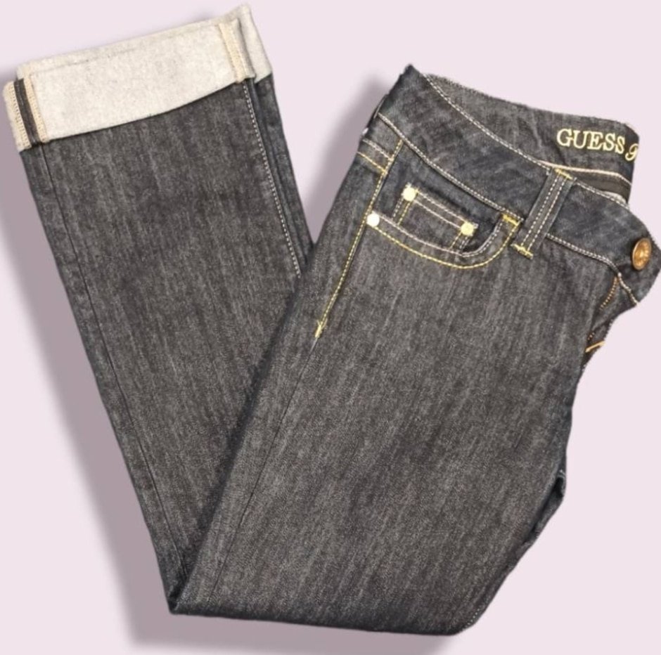 A pair of guess jeans with upturned hems.
