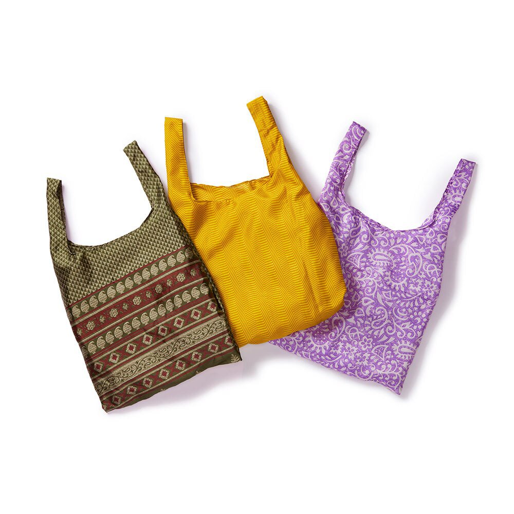 A brown bag a yellow bag and a purple bag all made from recycled saris