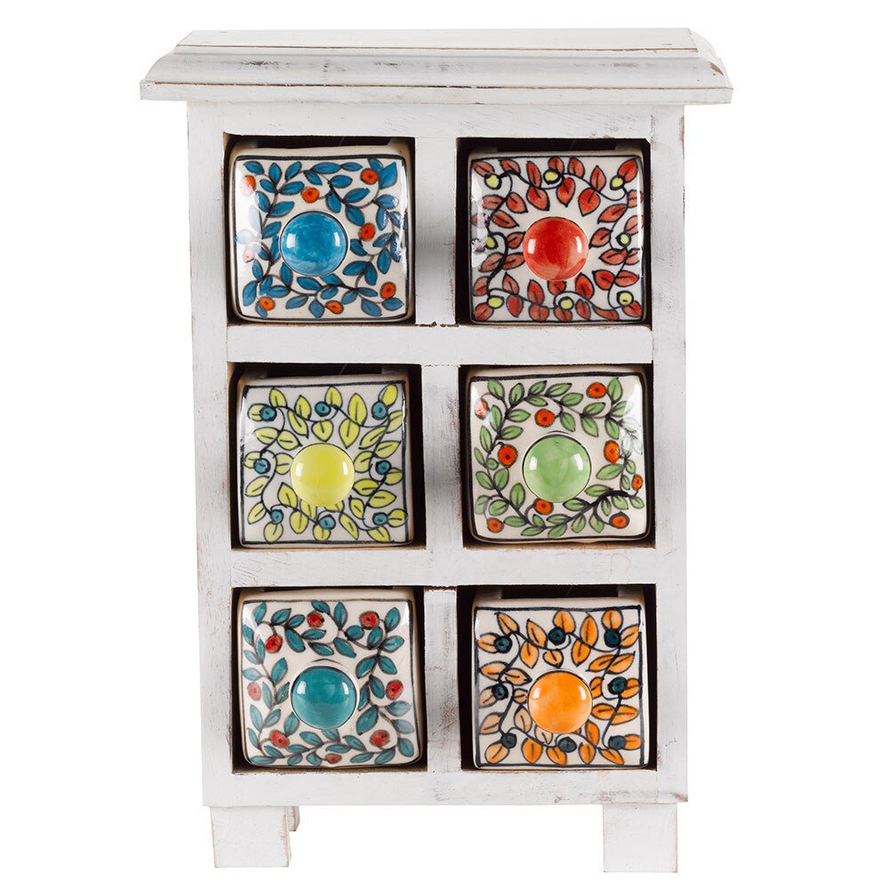 A small spice chest with drawers each painted with a different colour ring of leaves