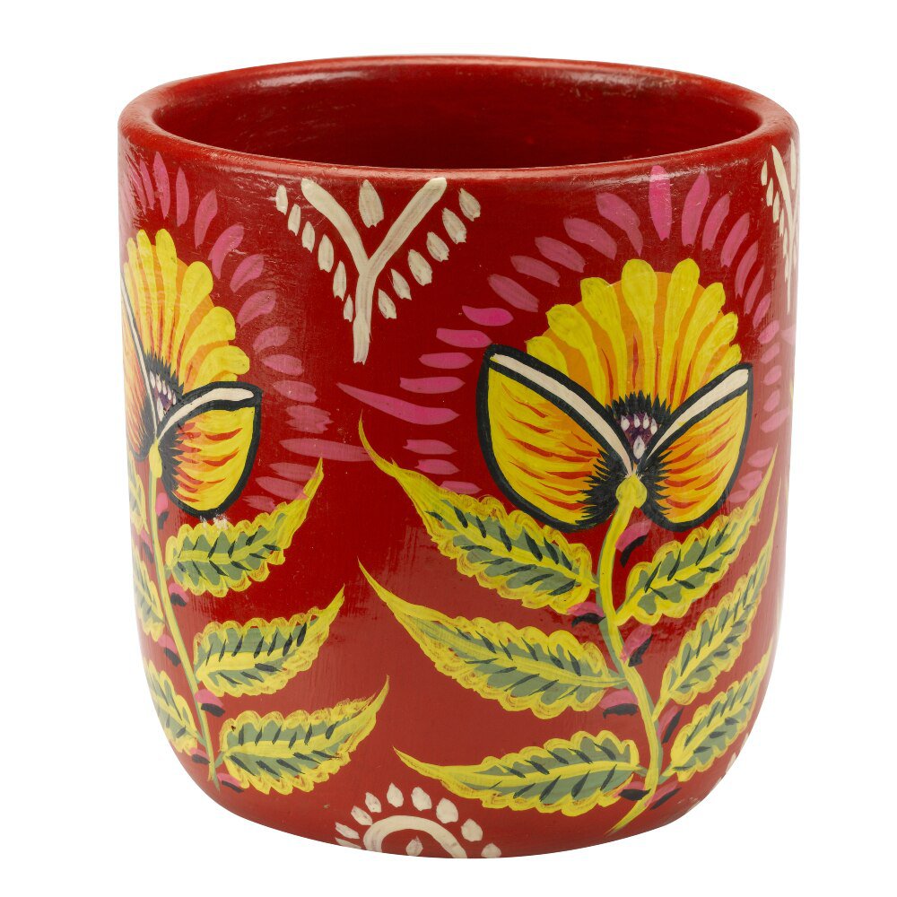 A red ceramic pot hand painted with a floral design