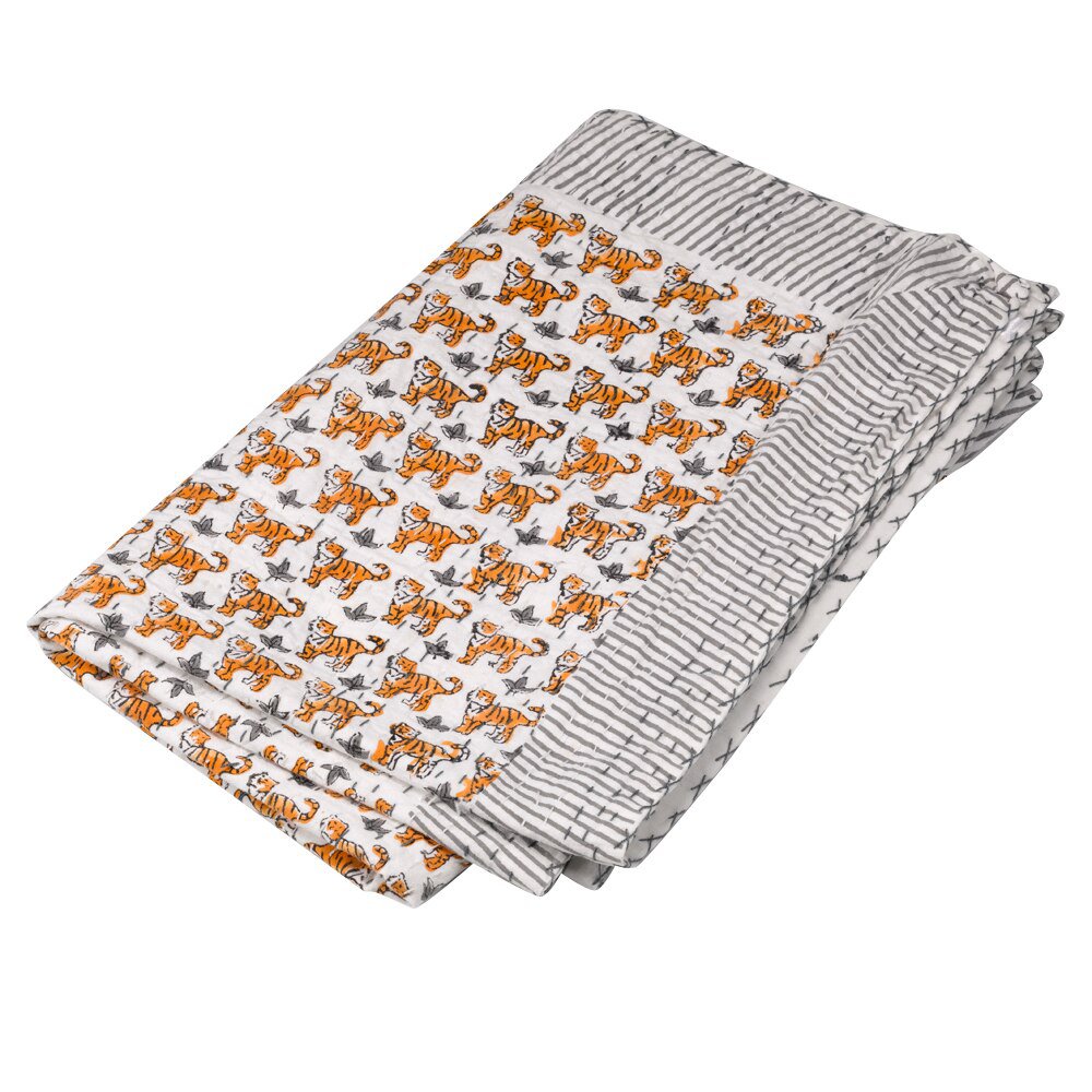 Cartoon tigers printed in rows on white cloth with a grey and white striped border