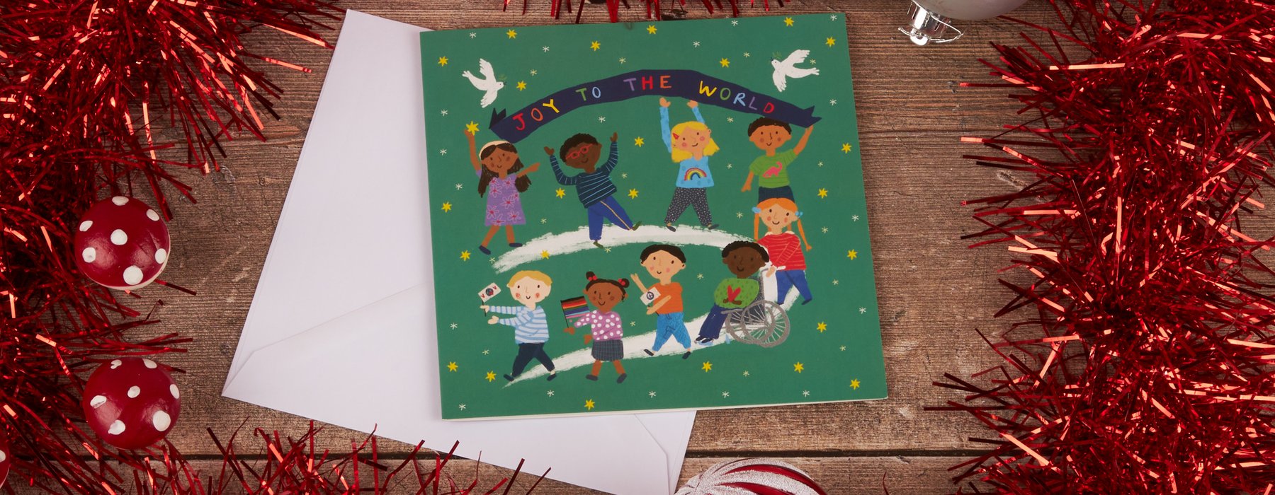 Joy to the World charity Christmas card featuring a cartoon of children from all around the globe