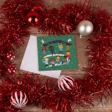 Joy to the World charity Christmas card featuring a cartoon of children from all around the globe