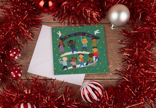 Joy to the World charity Christmas card featuring a cartoon of children from all around the globe