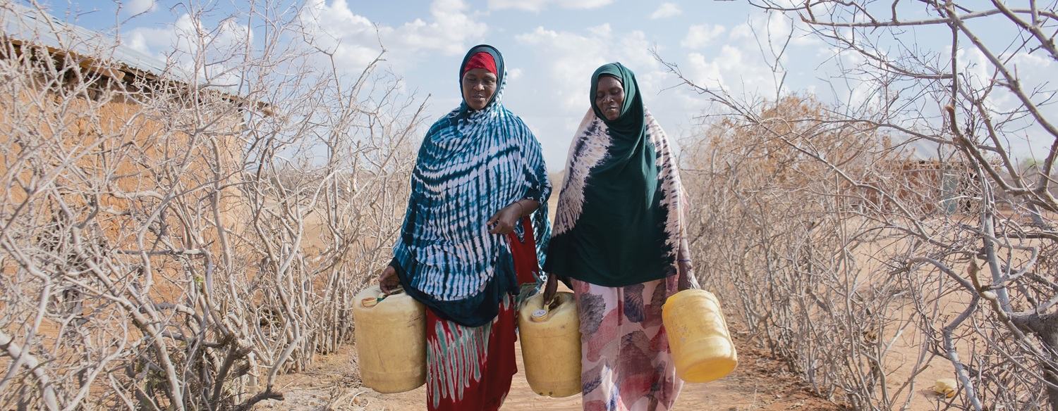 Hadija Jillo and Qali Chana, project participants in Hagarusu village in Isiolo County, on their way to fetch water.