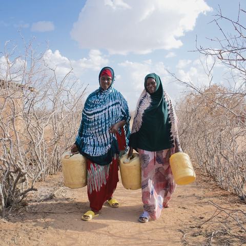 Hadija Jillo and Qali Chana, project participants in Hagarusu village in Isiolo County, on their way to fetch water.