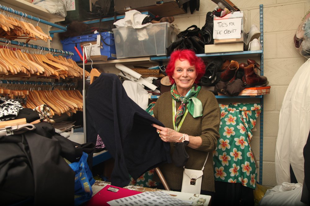 Isabella sorting through donations at the shop