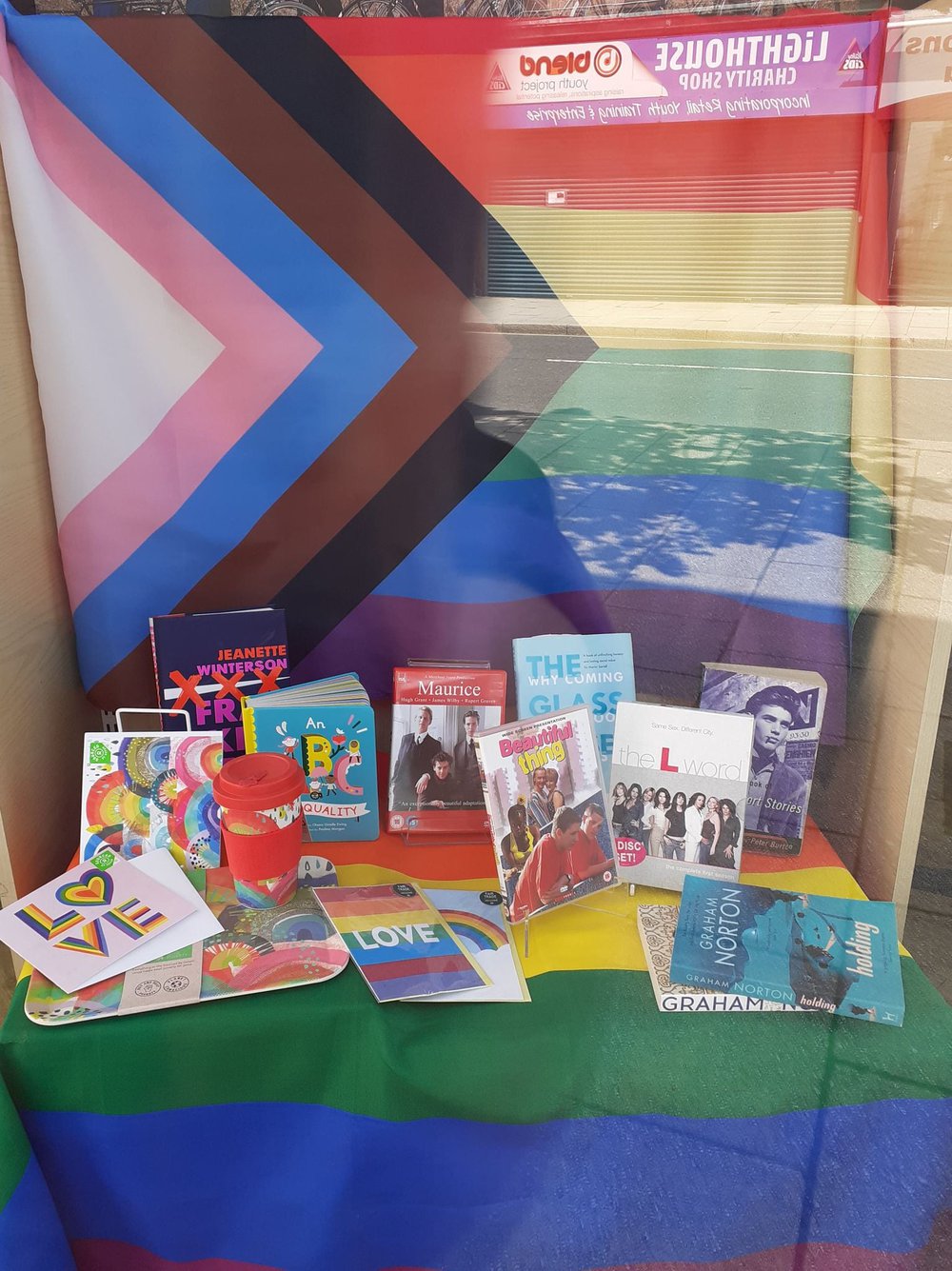 A Pride month shop window display with various books