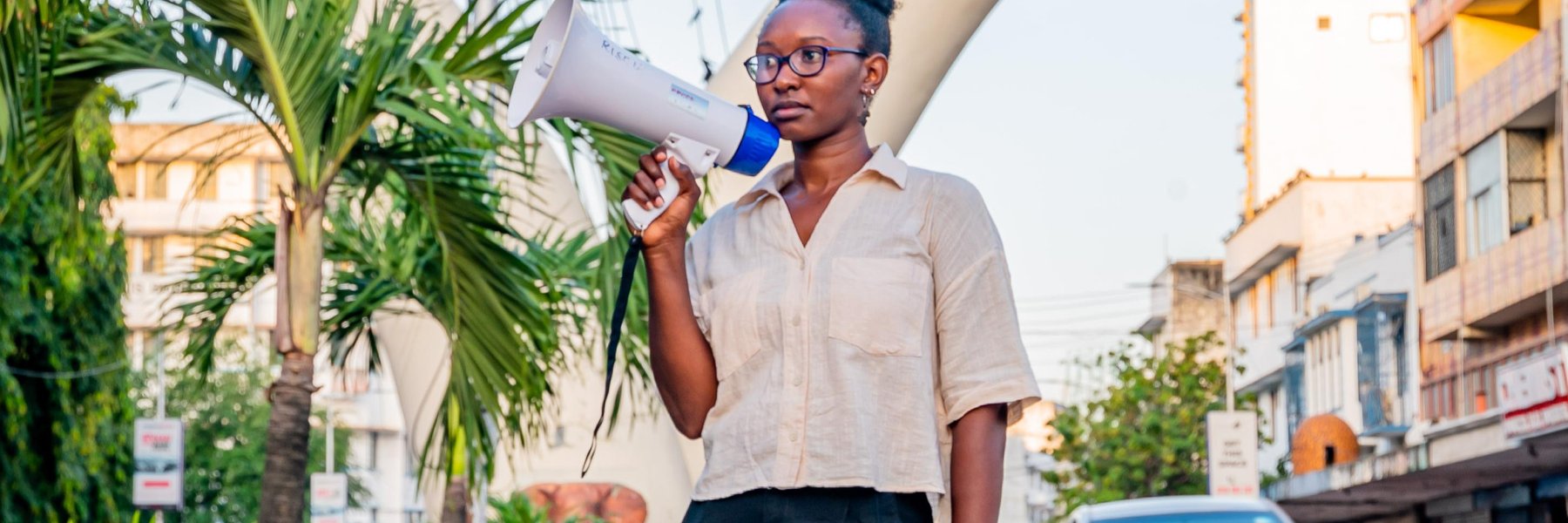 Joyce Koech standing with a megaphone in Mombasa