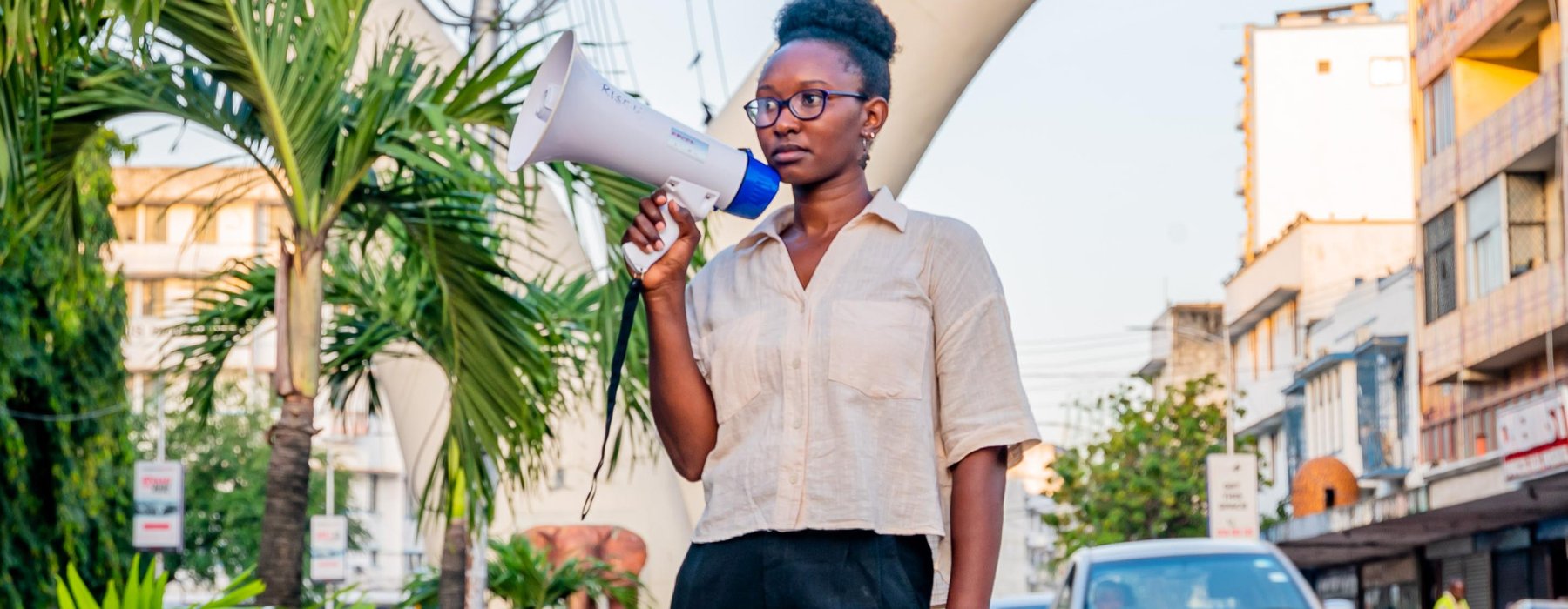 Joyce Koech standing with a megaphone in Mombasa