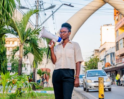 Joyce Koech standing with a megaphone in Mombasa