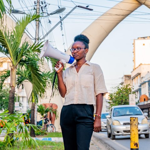 Joyce Koech standing with a megaphone in Mombasa