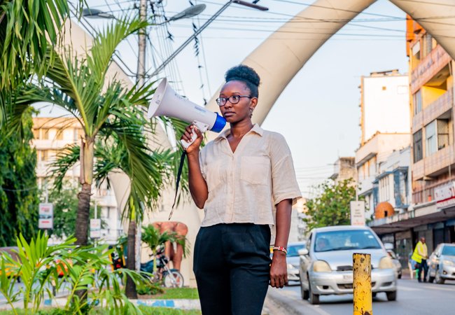 Joyce Koech standing with a megaphone in Mombasa