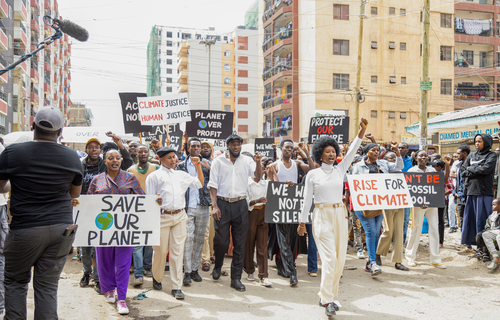 An image of Joyce leading a climate march through the streets