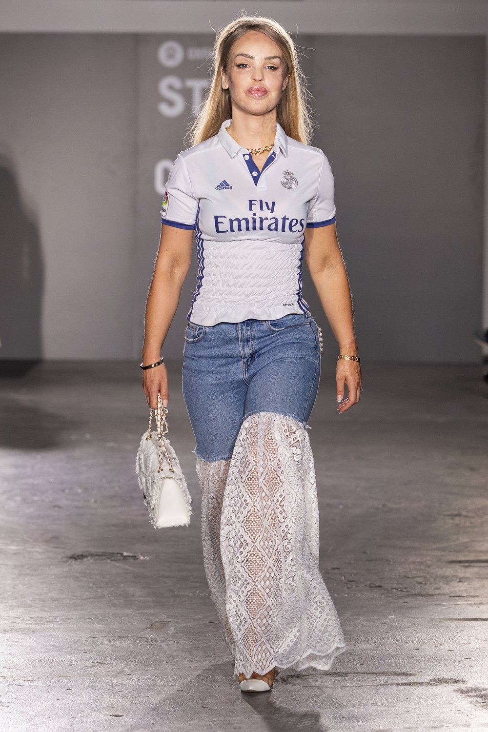 Katie Piper walking the catwalk in an upcycled outfit