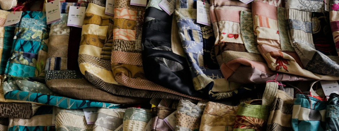 A image showing the selection of Loom bags, they are placed one by one to each other slightly overlapping. Each bag is unique with its own pattern made from different textiles.