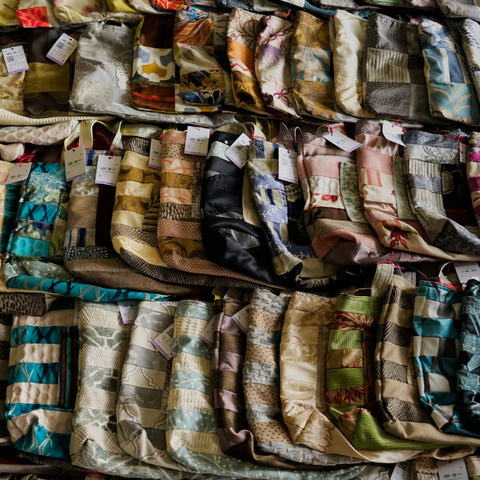 A image showing the selection of Loom bags, they are placed one by one to each other slightly overlapping. Each bag is unique with its own pattern made from different textiles.